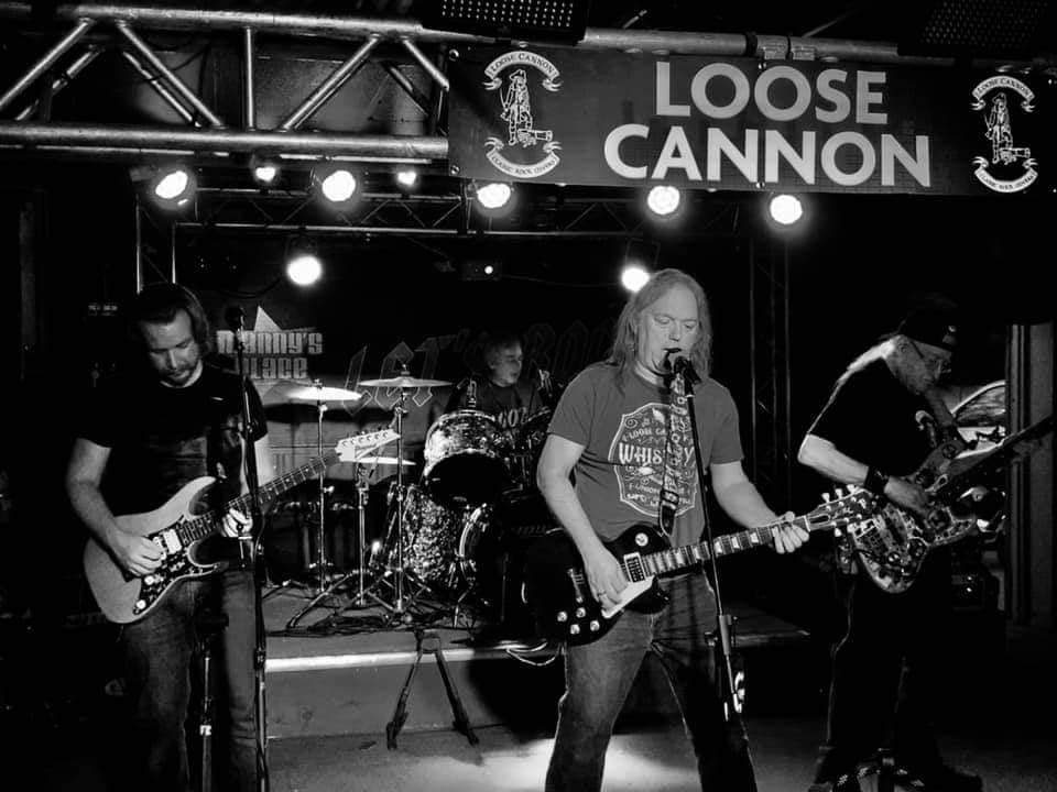 A band playing on stage in front of the crowd.