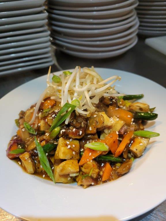 A plate of food with vegetables and noodles.