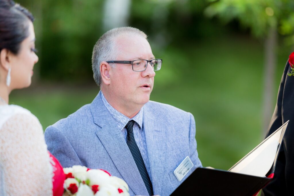 A man in glasses and a suit is reading