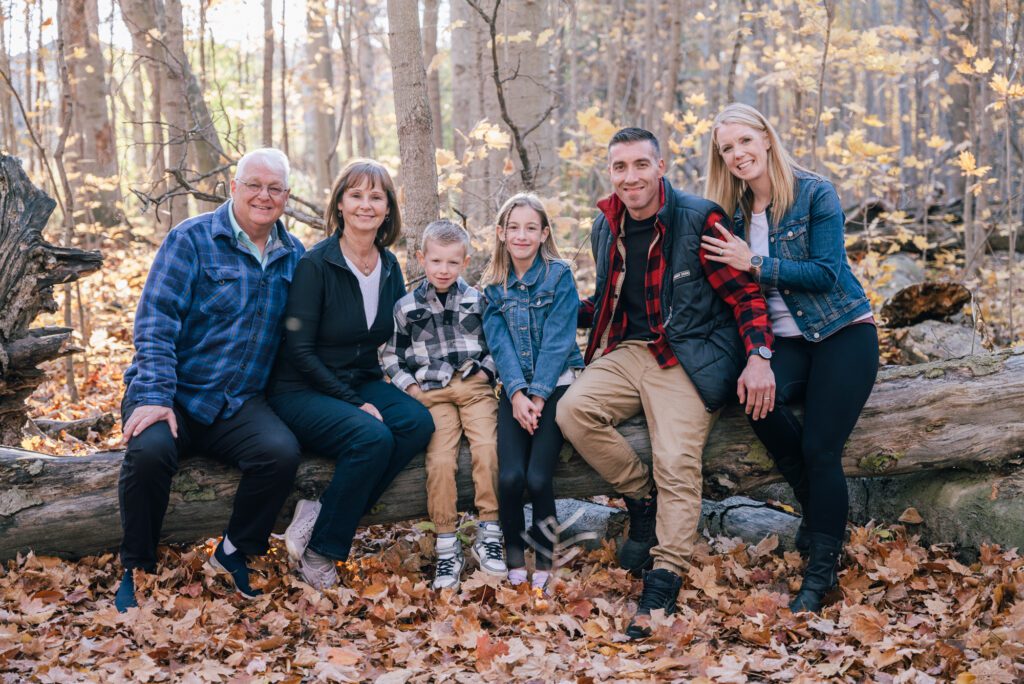 A family posing for a picture in the woods.