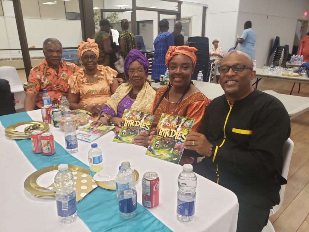 A group of people sitting at a table with books.