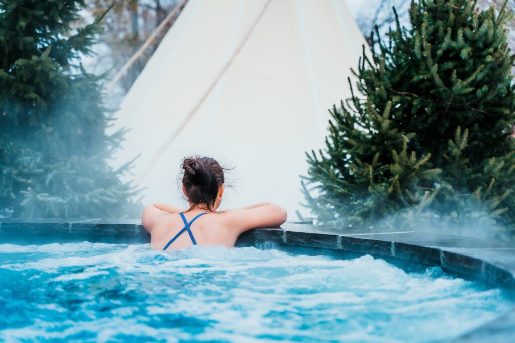 A woman in a blue bikini sitting in the pool