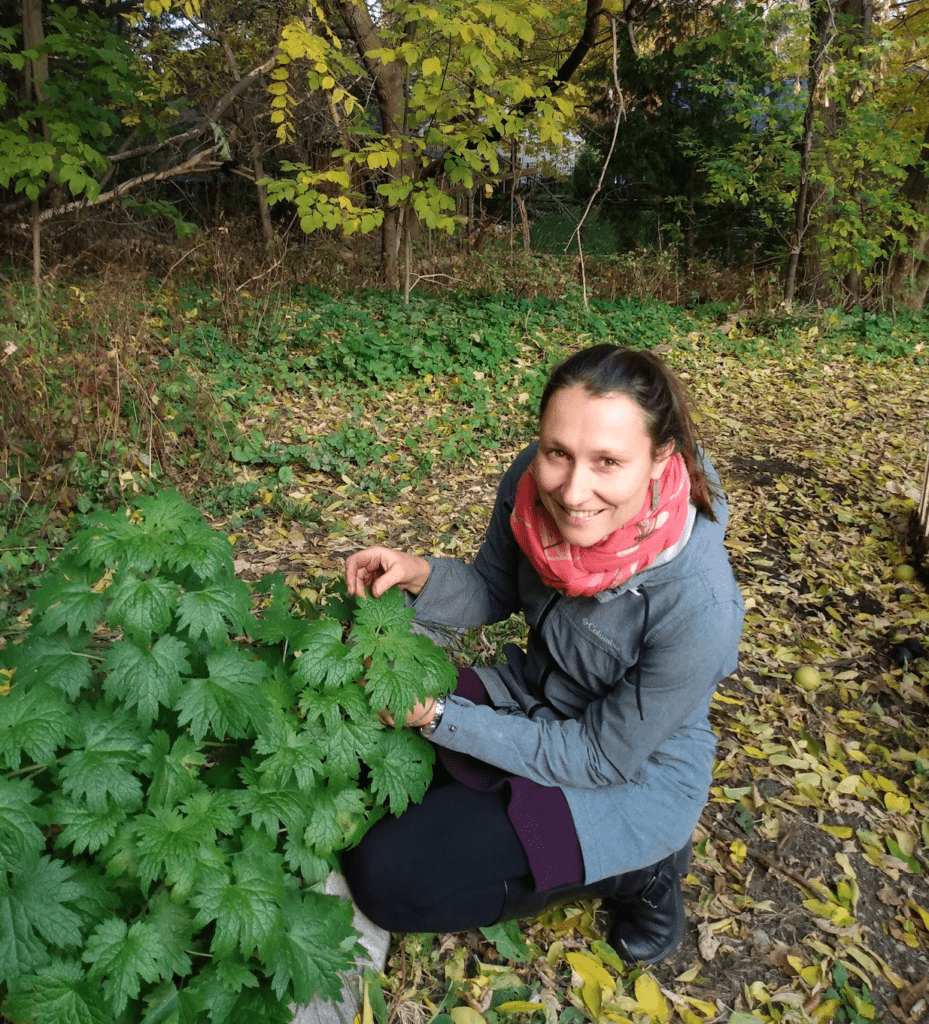 A woman is holding onto some leaves